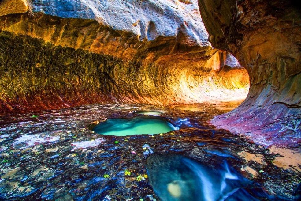 Cave pool with turquoise water and colorful rock formations